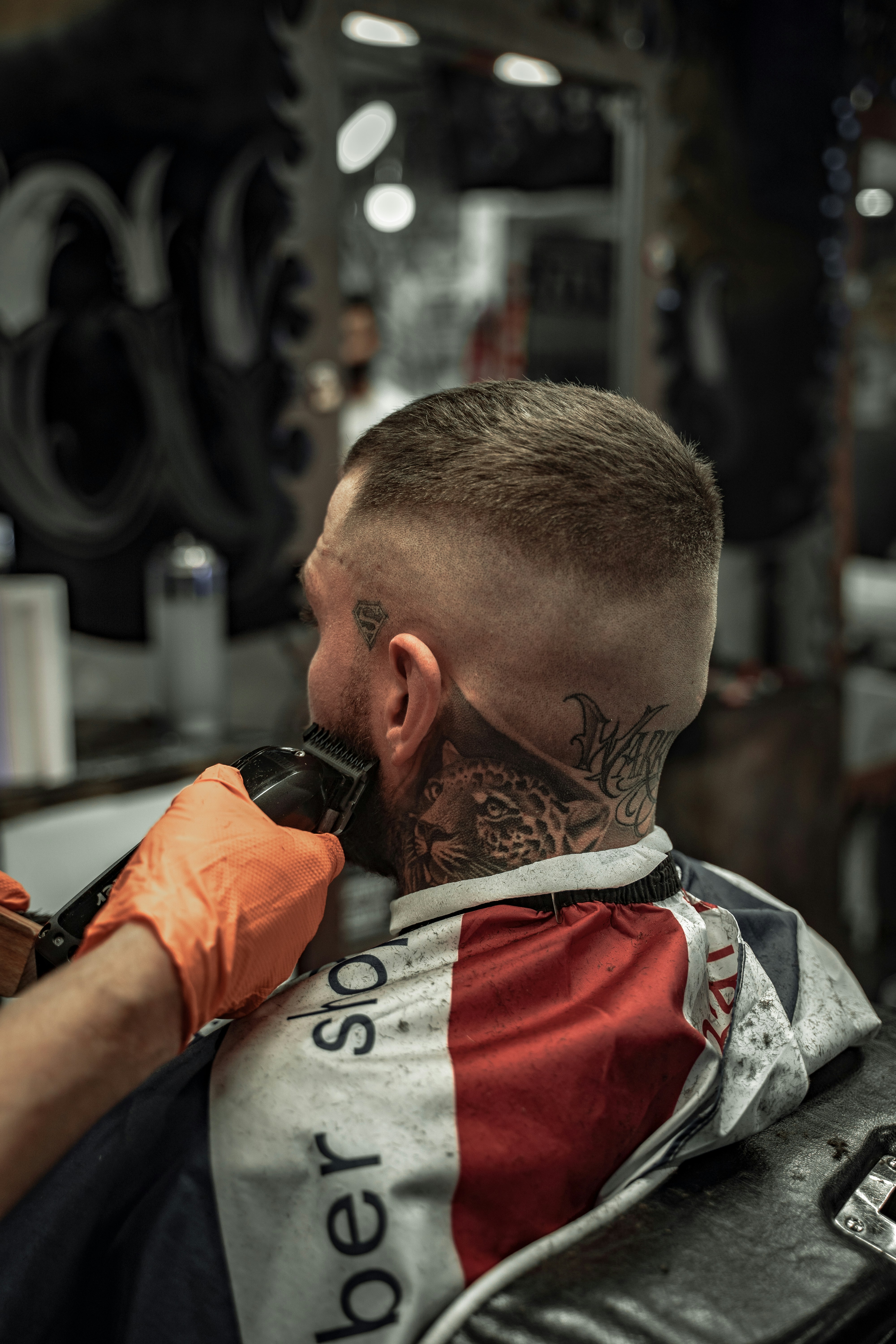 A person getting their beard trimmed by a barber.