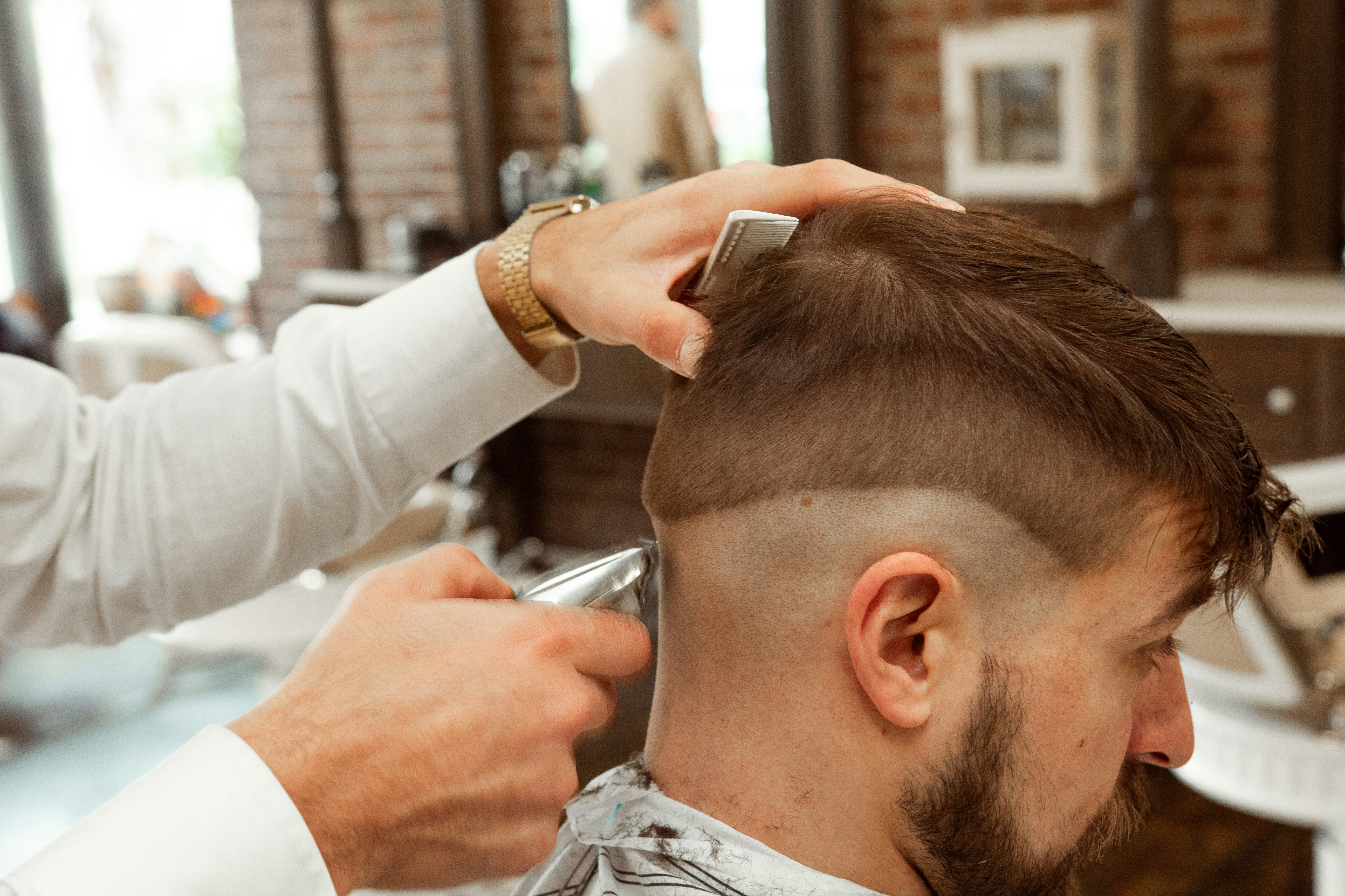 Man getting a haircut with clippers.