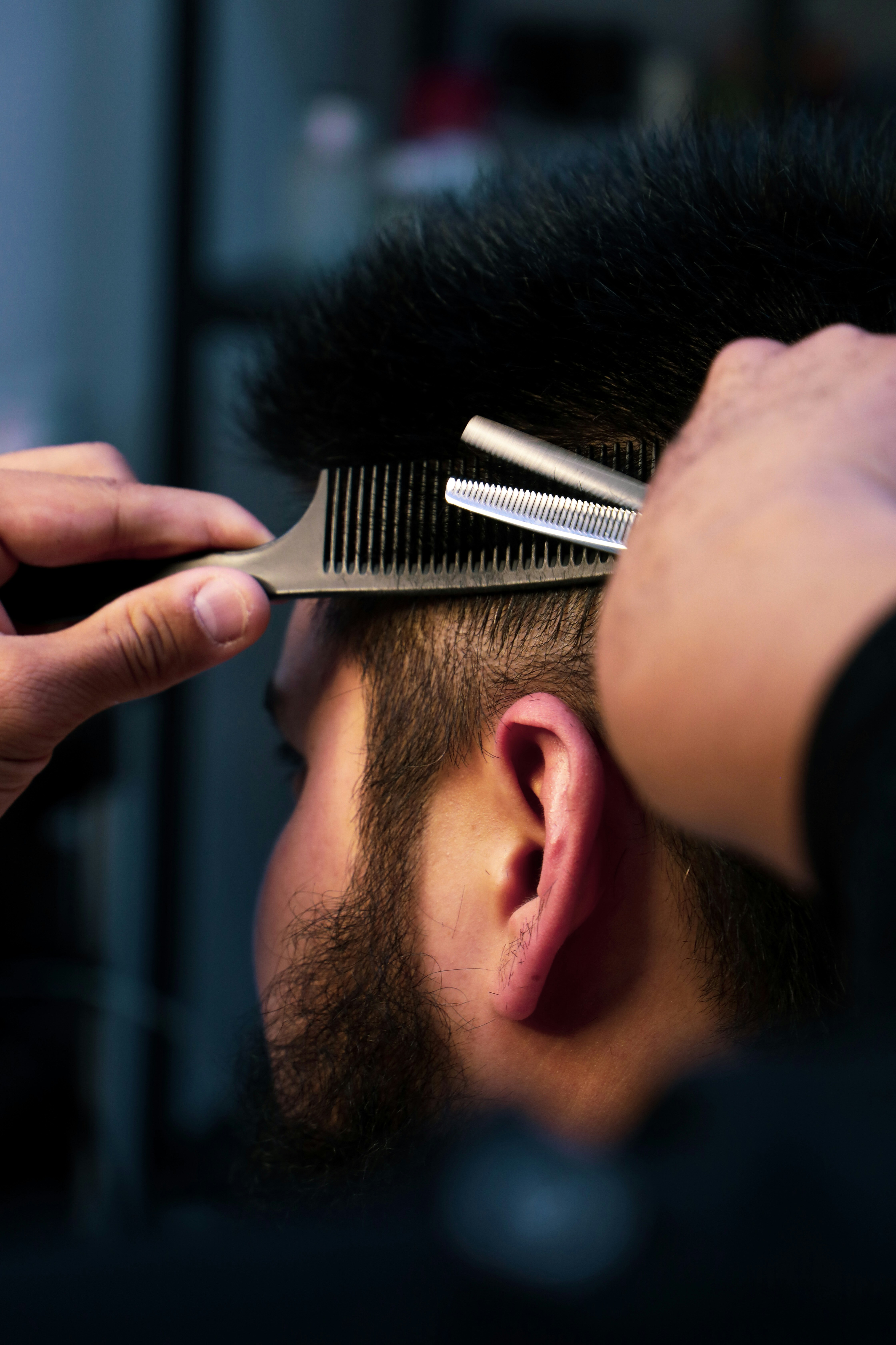 A man getting a haircut in a barbershop